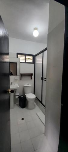 a bathroom with a toilet and a sink at Hotel Coconuco by Destino Pacifico in Coconuco