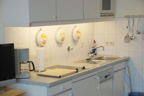 a kitchen with a sink and a counter top at App-Kleinhubbert in Westerland (Sylt)