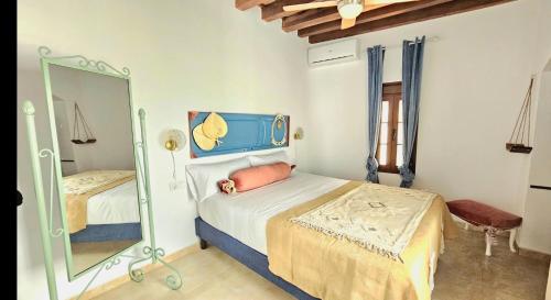 a bedroom with two beds and a mirror at Casa Bakara Vejer old town in Vejer de la Frontera