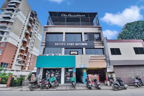 a hotel with motorcycles parked in front of a building at OYO Flagship 81479 Hotel The Stay Within in Rānchī