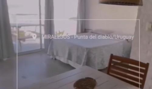 a table and a chair in a room at Miralejos in Punta Del Diablo