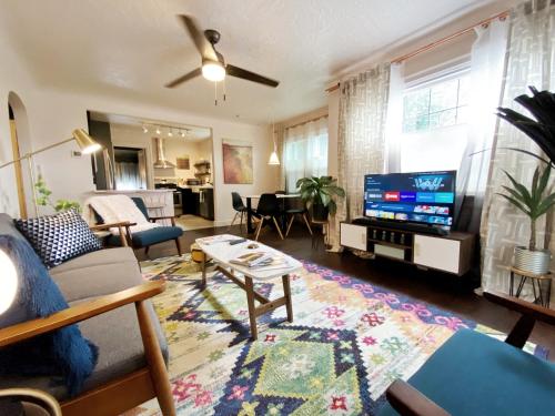 a living room with a couch and a tv at The Wesley Walla Walla in Walla Walla