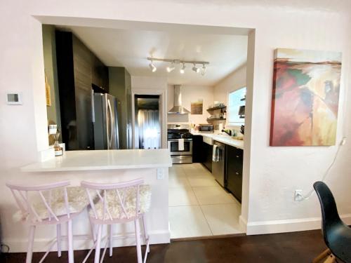 a kitchen with a counter and two bar stools at The Wesley Walla Walla in Walla Walla