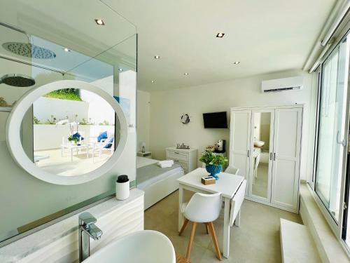 a bathroom with a mirror and a sink and a desk at Torre Pozzillo Beach in Cinisi