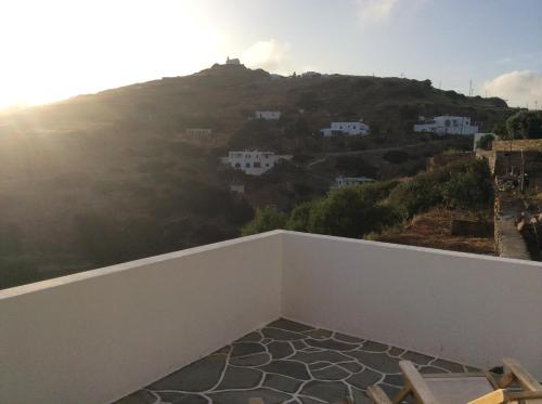 a balcony with a view of a mountain at Blue Sky in Ios Chora
