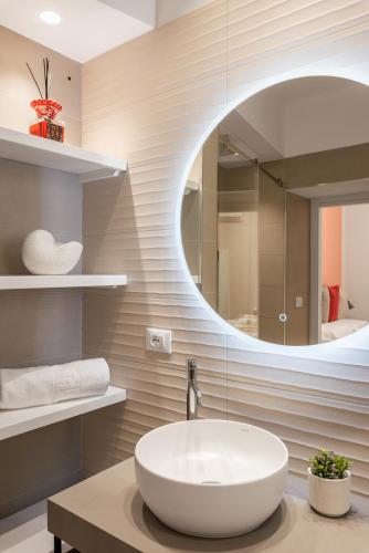 a bathroom with a sink and a mirror at LE PORTE DEL KASSARO in Palermo