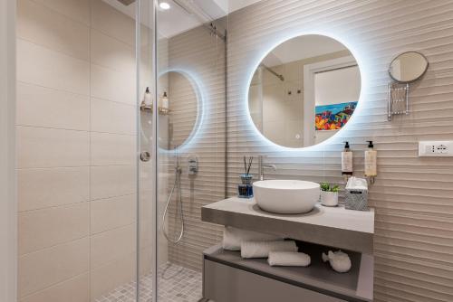 a bathroom with a sink and a shower at LE PORTE DEL KASSARO in Palermo