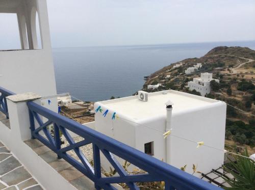 a view of the ocean from the balcony of a house at Blue Sky in Ios Chora