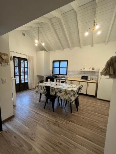 a large room with a table and a kitchen at Casita del Mar in Puerto Madryn