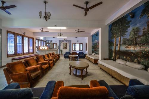 a living room with leather chairs and a couch at Hotel Vinayak in Udaipur