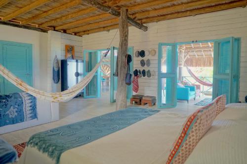 a bedroom with a bed with a hammock in it at Golden Sea Casa Boutique in Archibolds