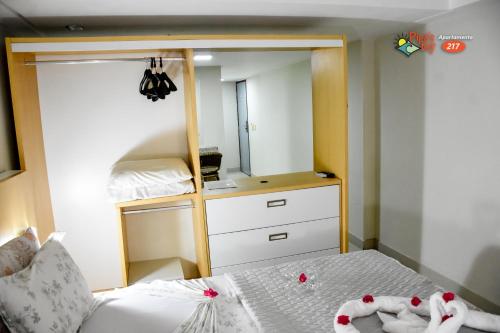 a bedroom with a bunk bed and a mirror at Flat no UNICO HOTEL BEIRA MAR Pipas Bay 217 in Pipa