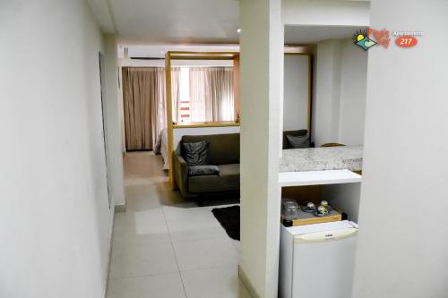 a hallway with a living room and a couch at FLAT PIPAS BAY 217 in Pipa