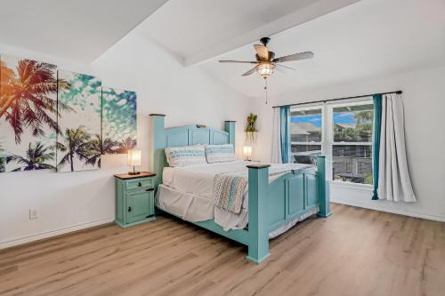 a bedroom with a blue bed and a window at Nassau #402 in Rockport
