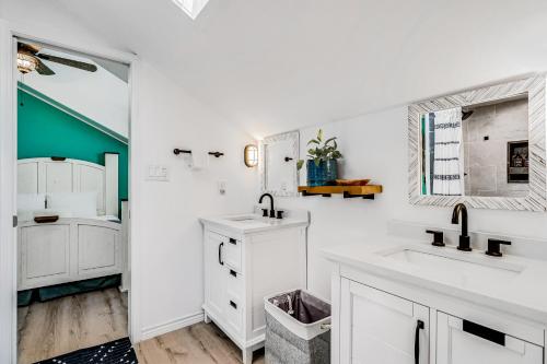 a white bathroom with a sink and a mirror at Nassau #402 in Rockport