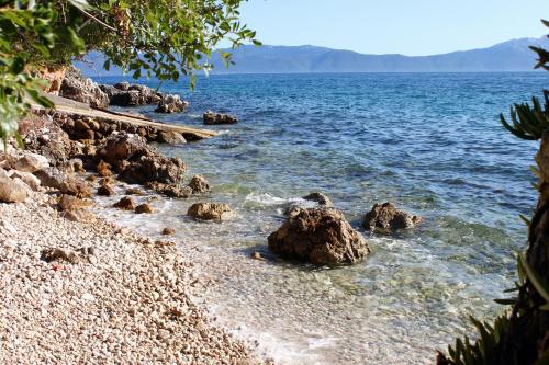 a beach with some rocks in the water at Apartments by the sea Podaca, Makarska - 21547 in Zaostrog