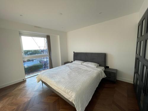 a bedroom with a bed and a large window at Kingston Star in Kingston upon Thames