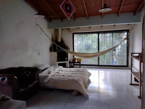 a bedroom with a bed and a large window at Casa Indigena de la Paz Shinawindua in Bogotá