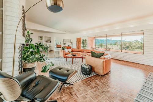 a living room with leather chairs and a couch at Jacuzzi, Walk to Trails, Stunning Views, Mid-Century Modern,Pool in Sedona