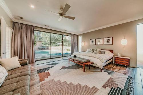 a bedroom with a bed and a large window at Jacuzzi, Walk to Trails, Stunning Views, Mid-Century Modern,Pool in Sedona