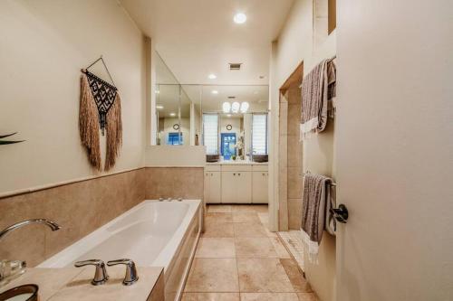 a bathroom with a tub and a sink at Jacuzzi, Walk to Trails, Stunning Views, Mid-Century Modern,Pool in Sedona