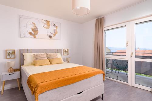 a bedroom with a bed and a balcony at Villa Del Mar Omiš in Omiš
