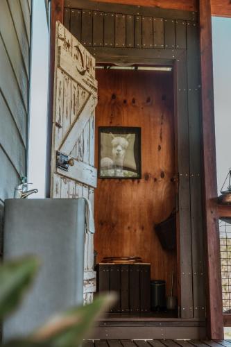 a door with a picture of a cat on the wall at Blackwattle Farm in Beerwah