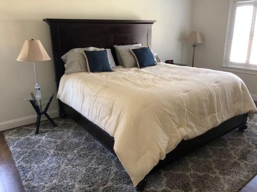 1 dormitorio con 1 cama grande con almohadas azules en Private Lakefront Home in Quiet Residential Area, 