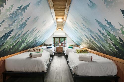 a room with four beds with a painting on the wall at The Creekstone in Idyllwild