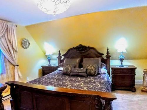 een slaapkamer met een groot bed met 2 nachtkastjes bij House on a Hill in Bushkill