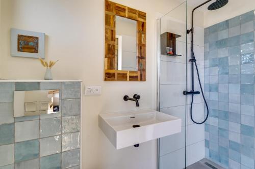 ein Bad mit einem Waschbecken und einer Dusche in der Unterkunft The Hut Bonaire in Kralendijk