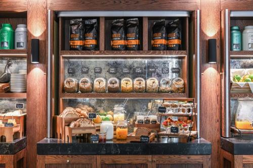 a bakery display case with bread and other food items at Powerhouse Hotel Tamworth by Rydges in Tamworth