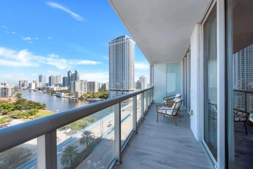 a balcony with a view of a river and buildings at Water View Building With Pool - 5-Min Walk To The Beach in Hallandale Beach