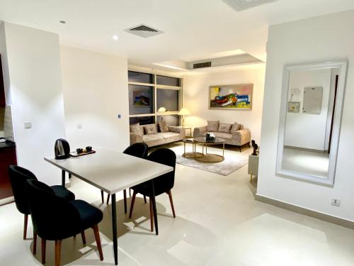 a dining room and living room with a table and chairs at One Constitution Avenue - Apartments by Superhost in Islamabad