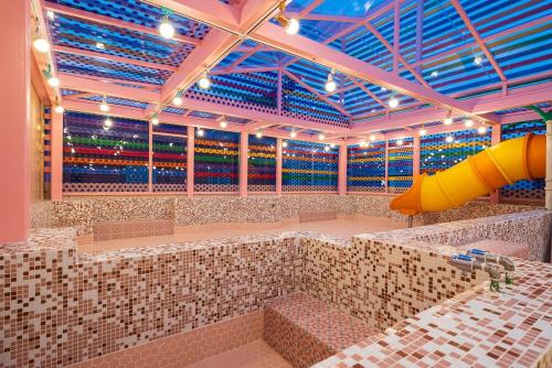 a large room with a large amount of tiles at Jangyu Almond Kids Hotel in Gimhae