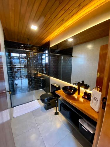 a bathroom with a sink and a toilet at Cabanas Arroio Da Serra in Cambará