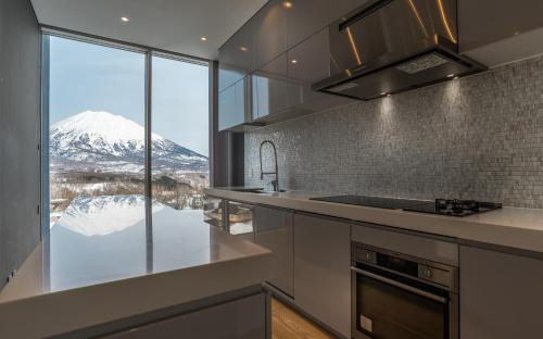 a kitchen with a view of a snow covered mountain at Terrazze in Niseko