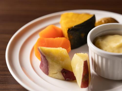 a plate of food with different types of food at Hotel Vista Matsuyama in Matsuyama