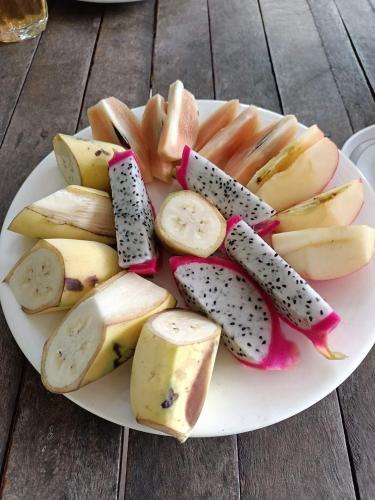 a plate of fruit and vegetables on a table at Phonluer Angkor Homestay, in Siem Reap