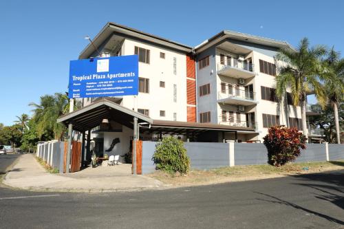 a building with a blue sign in front of it at Tropical Plaza Apt in Nadi