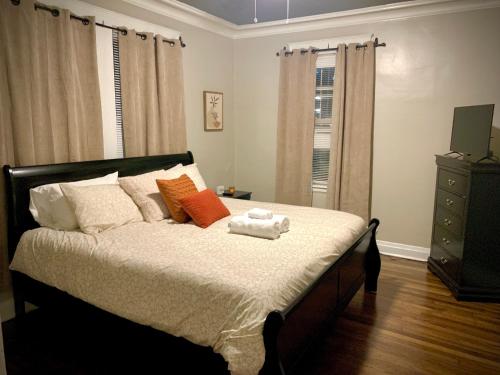 a bedroom with a bed with two towels on it at 2br Hideaway just 2 miles from Beale St and Overton Square! in Memphis