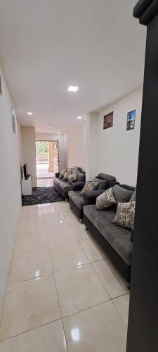 uma grande sala de estar com sofás num quarto em "La #4 Mi Casa es tu Casa"Apt #1 Giron, Azuay,Ecuador 