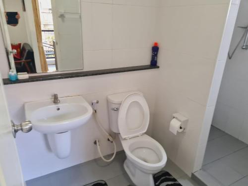 a bathroom with a sink and a toilet and a mirror at 1 Double bedroom Swimming pool Apartment for Rent in UdonThani With Gym Laundry in Udon Thani