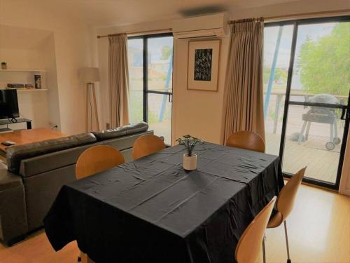 a living room with a table with chairs and a couch at Blue Oasis in Esperance