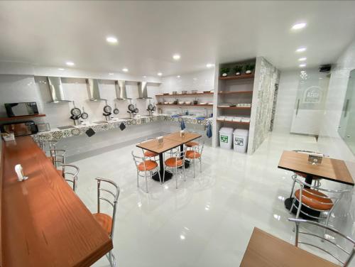 a restaurant with tables and chairs in a room at La Casa del Reloj - Zona de Hospitales in Mexico City