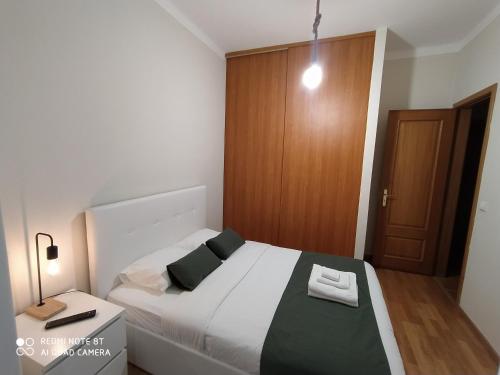 a bedroom with a bed with black and white pillows at MCR Barreiro - Lisboa in Lavradio