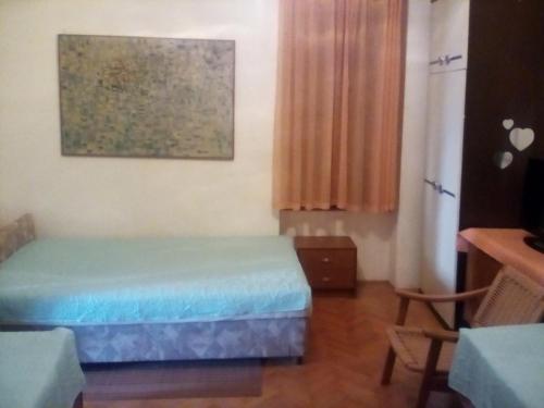 a bedroom with a bed and a painting on the wall at Apartman MICHI in Sveti Juraj