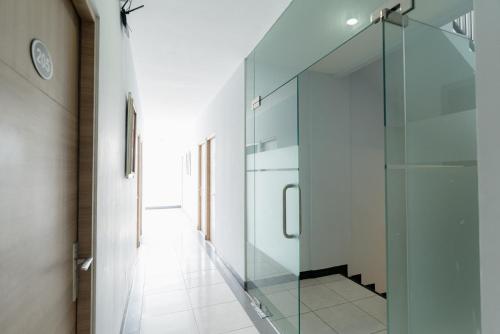 a hallway with a glass door in a house at RedDoorz near Puri Indah Lippo Mall 2 in Jakarta