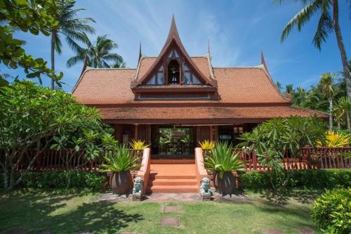 a house with a building with palm trees at Five Islands Beach House Samui in Amphoe Koh Samui