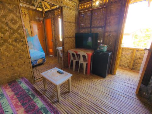 a room with a bed and a table and a tv at Truth be Found Ministry Resort in Jagna